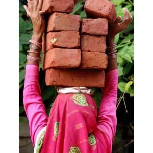  An Indian Woman Construction Worker Stacks Bricks on Her 