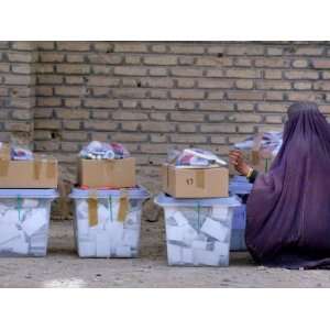  An Afghan Woman in a Burqa Oversees Ballot Boxes Stretched 